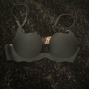 Black bra with cheetah lining. Perfect for low-cut tops. Size 34B